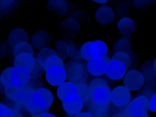 Abstract blur image of blue light of beautiful bokeh on black background. Blurred festive, night party and celebration bokeh background.