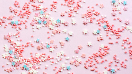 Abstract pink background with many small candies.