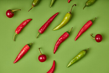 Flat lay composition with many hot chili peppers on green background. fresh fruits vegetables concept. top view