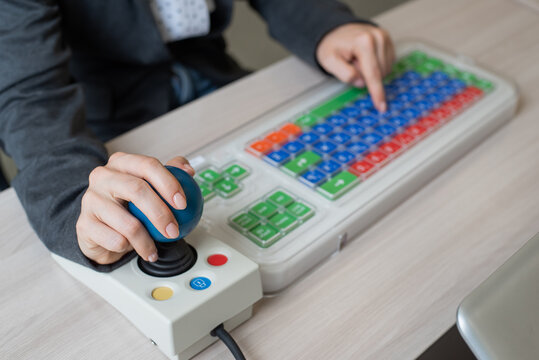 Woman With Cerebral Palsy Works On A Specialized Computer Mouse.