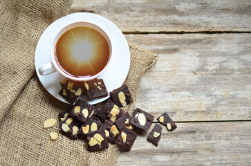 Cup of coffee and tasty cookies on wooden background. Tea time and breakfast concept.