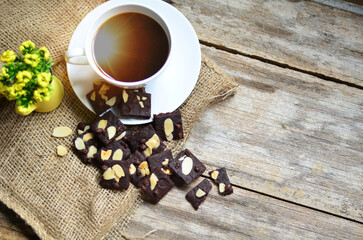 Cup of coffee and tasty cookies on wooden background. Tea time and breakfast concept.