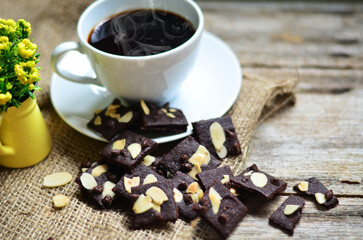 Cup of coffee and tasty cookies on wooden background. Tea time and breakfast concept.