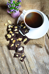 Cup of coffee and tasty cookies on wooden background. Tea time and breakfast concept.