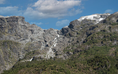Fototapeta na wymiar Stunning variegated mountains along the mythical carretera Austral (Southern Way), Chile's Route 7. It runs through forests, fjords, glaciers, canals and steep mountains in rural Patagonia