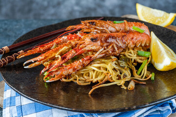 Langoustines with ginger, spring onions and crispy fried egg noodles