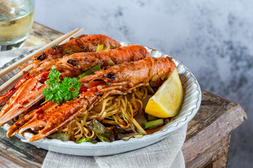 Langoustines with ginger, spring onions and crispy fried egg noodles