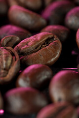 a lot of coffee beans lie in a pile close-up macro