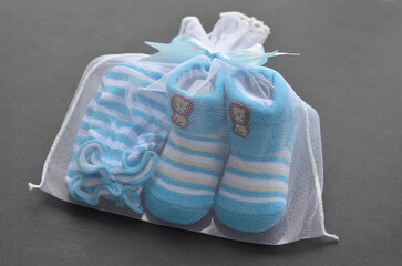 Blue colour newborn booties and mitten on black background