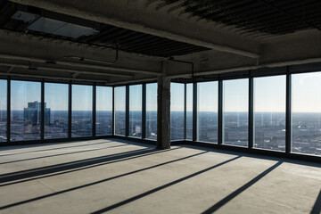 Angle view of empty office space in a tall highrise awaiting development in large urban area