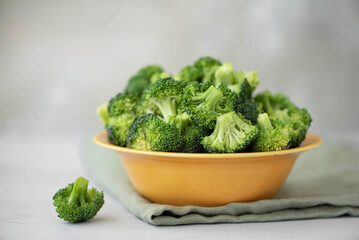 fresh broccoli florets in a yellow bowl
