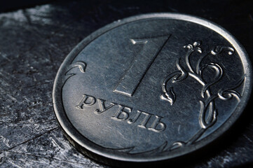 Russian coin denominated 1 ruble. shines on a scratched metal surface. close-up. translation of the...
