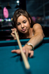 beautiful brunette about to shoot snooker