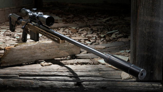 Bolt action rifle and silencer in old building