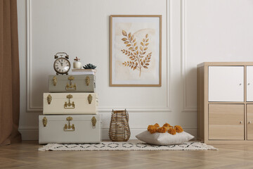 Many vintage storage trunks near white wall in room