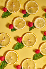 High vitamin C. bright Fresh lemon citrus and raspberry fruit with mint isolated on yellow...