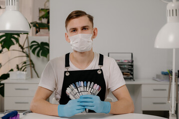 Professional male manicurist at workplace