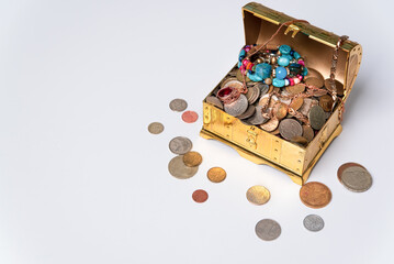 Open treasure chest on white background, coins, jewelry, gold, wealth