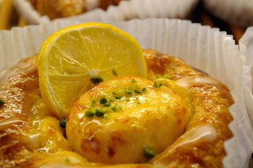 Denish pastry with lemon slices and cheese in a gown.