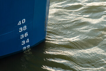 Draft mark on a bow of a blue ship
