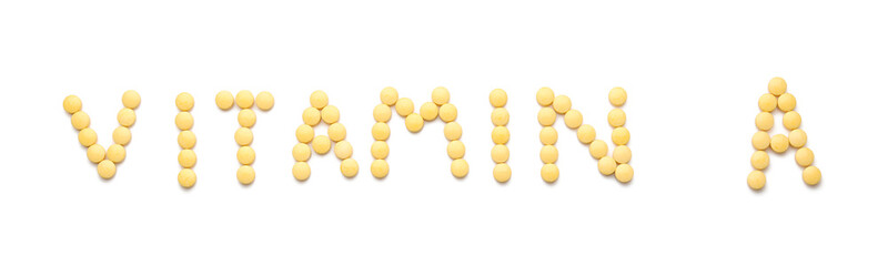 Text VITAMIN A made of yellow pills on white background