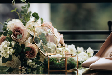 Gold wedding rings on a decorative green moss in a handmade glass box. Wedding accessories