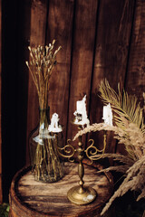 Decorations of candlesticks and dry grass in the style of boho