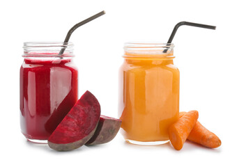 Mason jars of healthy carrot and beet smoothie on white background