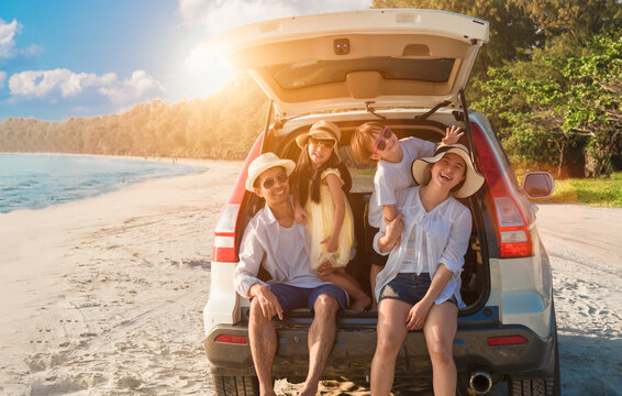 Group Of Happy Asian Family Fun Travel On Road Trip In Vacation At Beach. Father, Mother, Daughter, Son With Enjoying On Hatchback In Seaside In Summer Holiday.