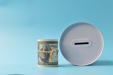 Money banknotes and money box isolated on a blue background. Financial, investment and save money concept
