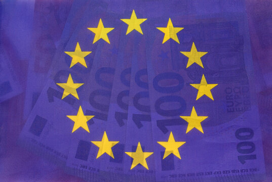 the beautiful blue flag of the european union shines through and under it new euros