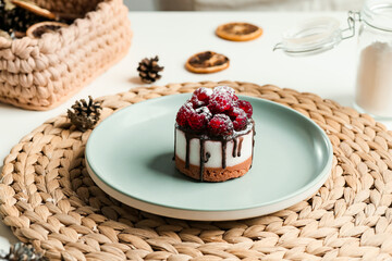 Cake with chocolate and raspberries on a plate close-up