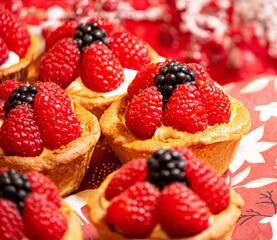 Freshly baked baskets with curd cream and strawberries
