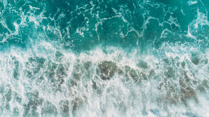 Fototapeta premium Beach and waves from top view. Turquoise water background from top view. Summer seascape from air. Top view from drone. Travel concept and idea