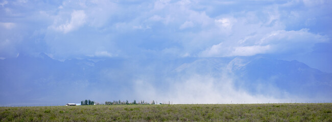 Sand storm blowing across the Colorado plains near the San Juan Mountains