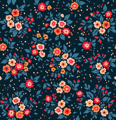 Beautiful floral pattern in small abstract flowers. Small colorful flowers. Dark Blue background. Ditsy print. Floral seamless background. The elegant the template for fashion prints. Stock pattern.