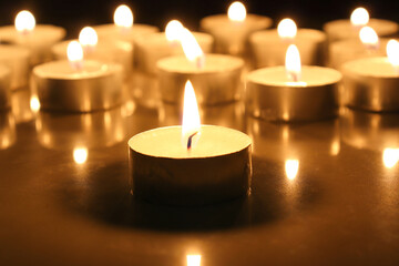 burning a lot candles in the darks Selective focus.