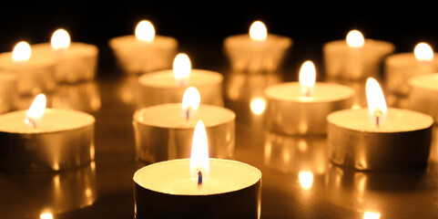 burning a lot candles in the darks Selective focus.