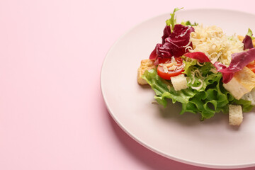 Plate with tasty vegan Caesar salad on pink background, closeup