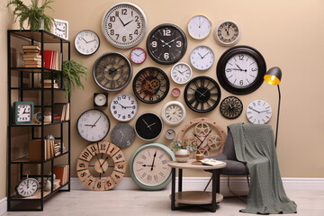 Stylish room interior with collection of wall clocks