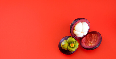 Pile of ripe mangosteen on wooden table background.