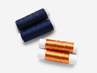 Different thread spools on white background