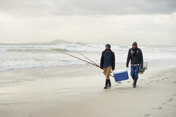 Heading off for a days fishing. Shot of a two friends fishing on an early overcast morning.