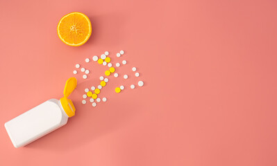 Scattered pills on a pink background, flat lay.