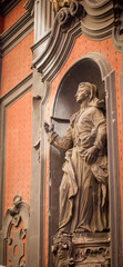 Fototapeta na wymiar religious statue on a Church wall in Naples Italy 