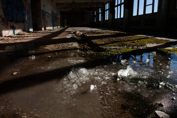 ice lies on the floor of an abandoned workshop