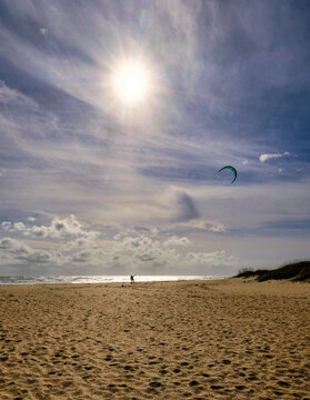 Vertical image of a parasailer on the beach on the Outer Banks of North Carolina