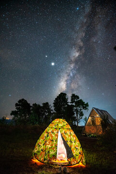 The Milky Way on the sky with a lighting Tent on the northern of Thailand