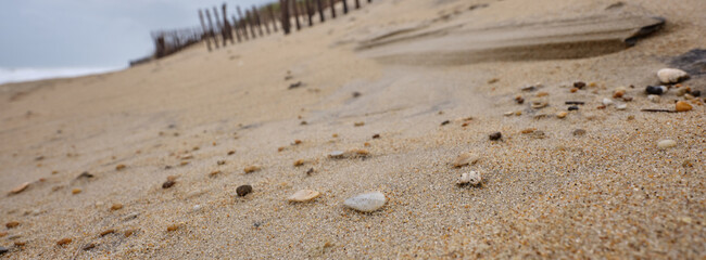 Panoramic image of small surf polished and worn stones on a beach in the Outer Banks of North...