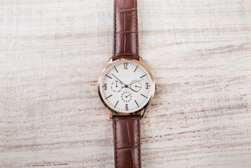 men's watch on a wooden background.